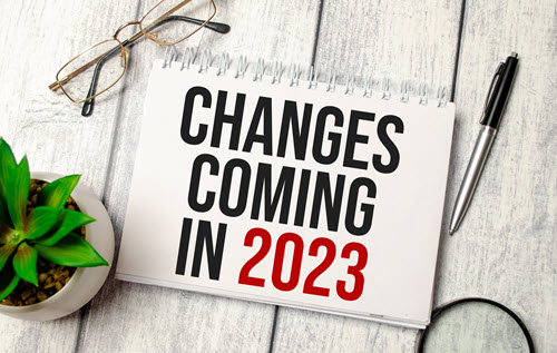 A decorative image of a spiral-bound notebook sitting on a desk that states CHANGES COMING IN 2023.