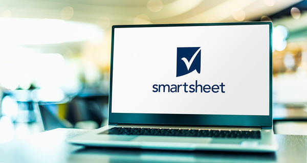 A laptop computer dispaying the logo for Smartsheet