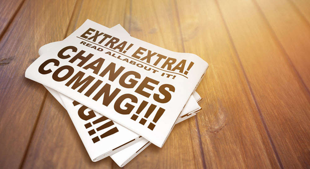 A decorative image showing a stack of newspapers that all announce that changes are coming.