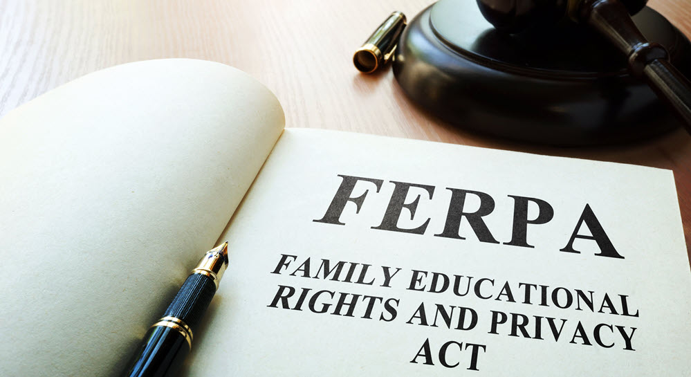 A notebook on a judge's bench with "FERPA - FAMILY EDUCATIONAL RIGHTS AND PRIVACY ACT" written in it. A pen rests between the pages.