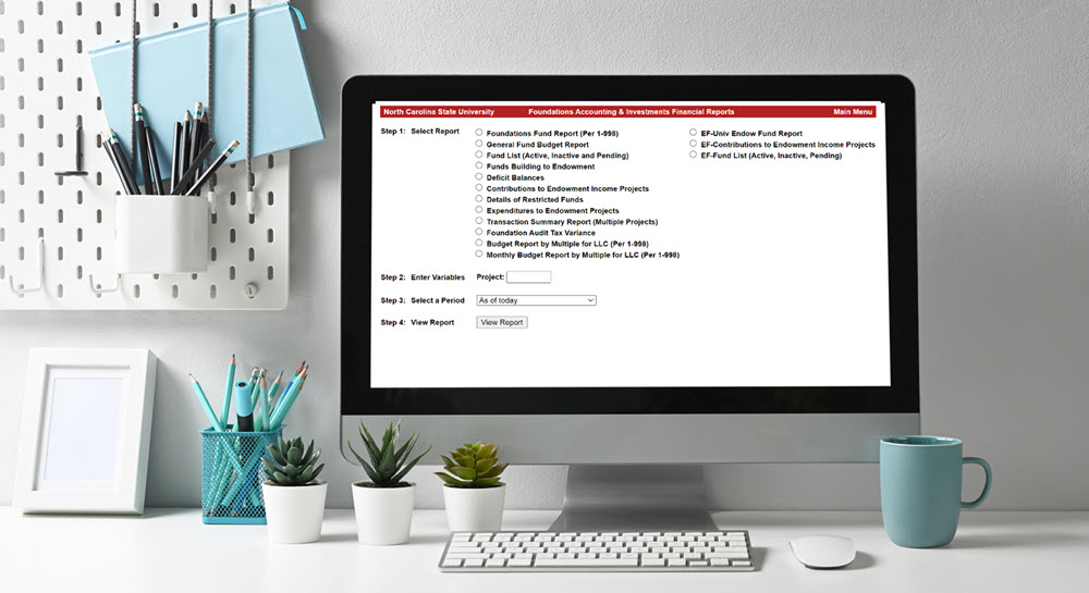 A desktop computer displaying the Foundations Accounting and Investments Financial Reports dashboard