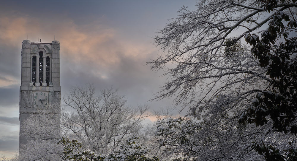 A winter scene on NC State's campus with the belltower in the background