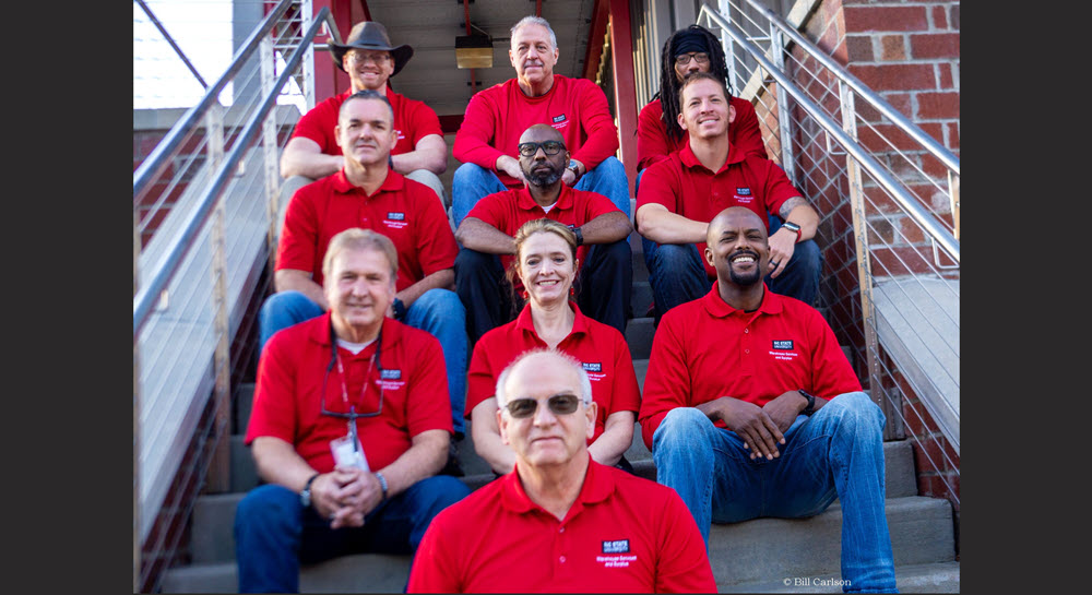 Bill Carson, Assistant Director for Materials Support, posing with his Materials Support team