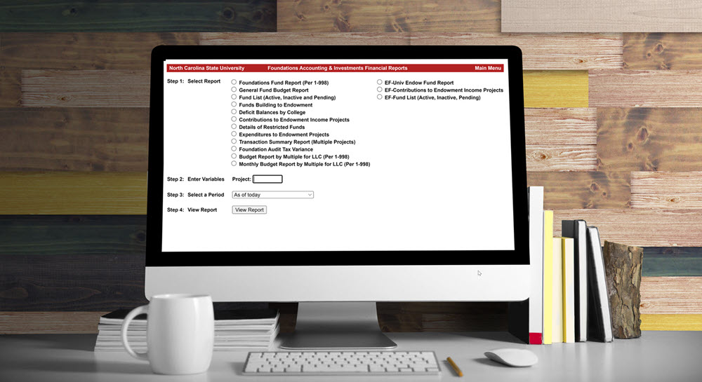 A desktop computer with the Foundations Accounting and Investments Financial Reports dashboard open