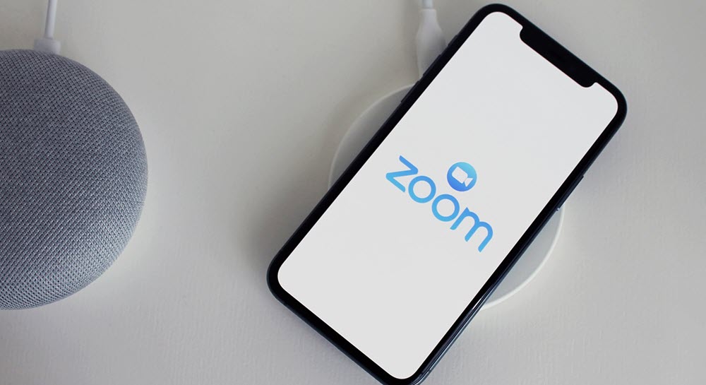 A cell phone with the Zoom logo displayed