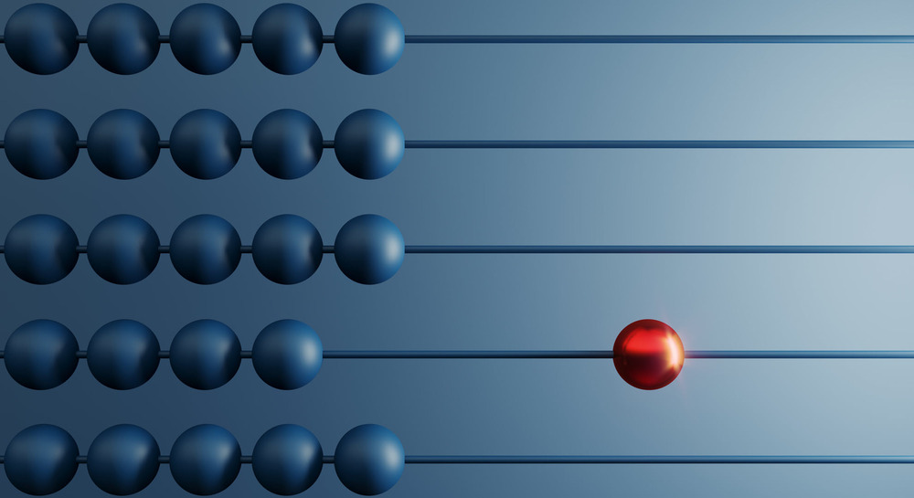 An abacus with blue beads aligned to the left and one red bead aligned to the right