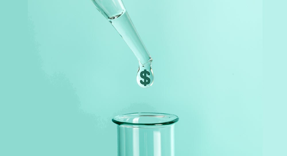 A dropper squeezing a drop of clear liquid into a test tube. The droplet has a dollar symbol in it.
